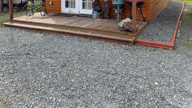A wooden cabin with a covered porch, a grill, and a sign indicating no parking. - Sockeye Chalet at Redbow (Sterling)