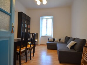 A living room with a sofa, chairs, a dining table, and a bookshelf. - Charming Rovinj Haven (Rovinj)