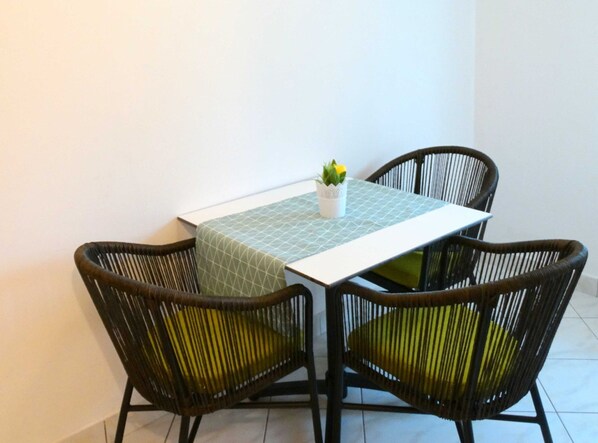 A small dining area with a table and four chairs.