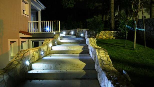 A stone staircase leading to a house at night, illuminated by lights. - Seaside Escape Selce Apartments (Crikvenica)