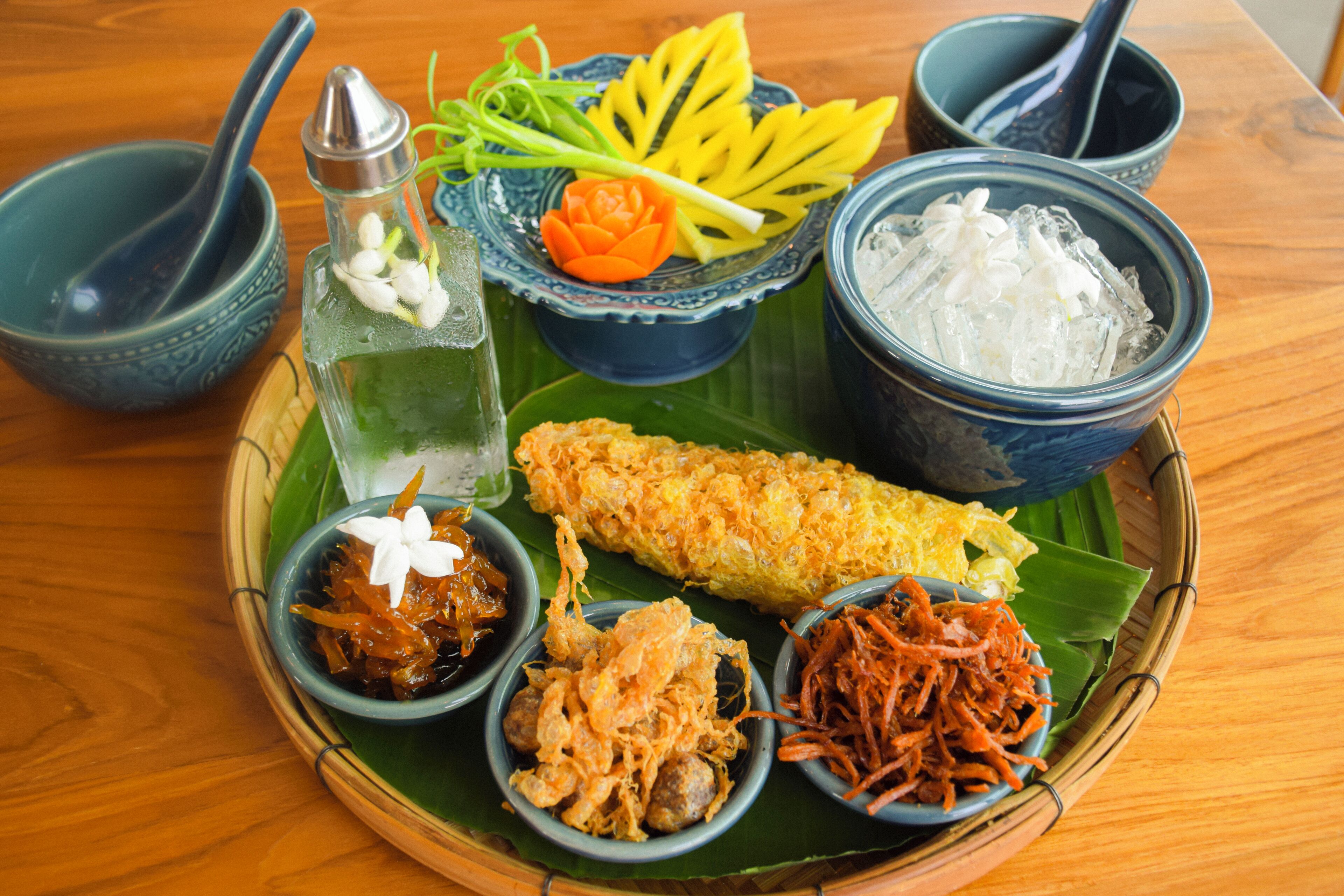 A traditional meal with various dishes on a wooden table.