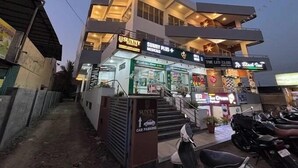 A multi-story building with a medical clinic on the ground floor, a car parking area, and a club on the upper floor. - Sunny Executive Satara (Satara)