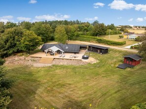 A large property with a main building, a covered patio area, and a separate structure.