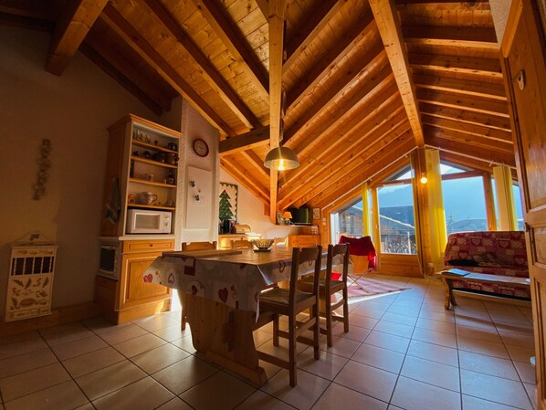 Enjoy meals at the dining table under a pendant light, with a microwave and refrigerator for basic food preparation.