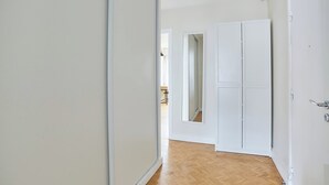 A hallway with white doors and a wooden floor. - 2 Bedroom Flat Centre de Paris - Eiffel Tower View (Paris)