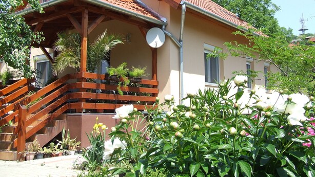 A two-story house with a balcony, satellite dish, and a chimney. - Well-kept apartment in Fonyod for 4-5 people within walking distance of the lake - new air conditioning (Fonyód)