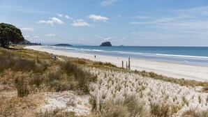 A beach with sand dunes and a clear sky.