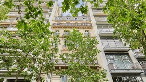 A multi-story building with balconies, surrounded by trees. - Incredible Apartment Etoile Porte Maillot (Paris)