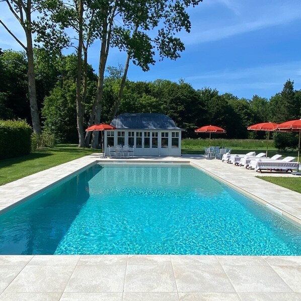 Seasonal outdoor pool, open 2:00 PM to 7:00 PM, pool umbrellas