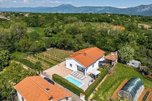 A house with a swimming pool, a greenhouse, and a view of mountains. -  Pool House Kristina (Sveta Nedelja)