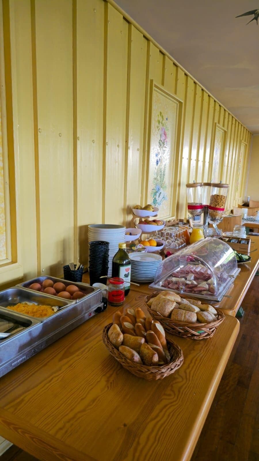 A buffet setup with various food items and beverages.