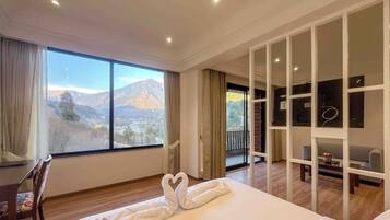 Deluxe Suite, Balcony, Mountain View | Desk, laptop workspace, soundproofing, iron/ironing board