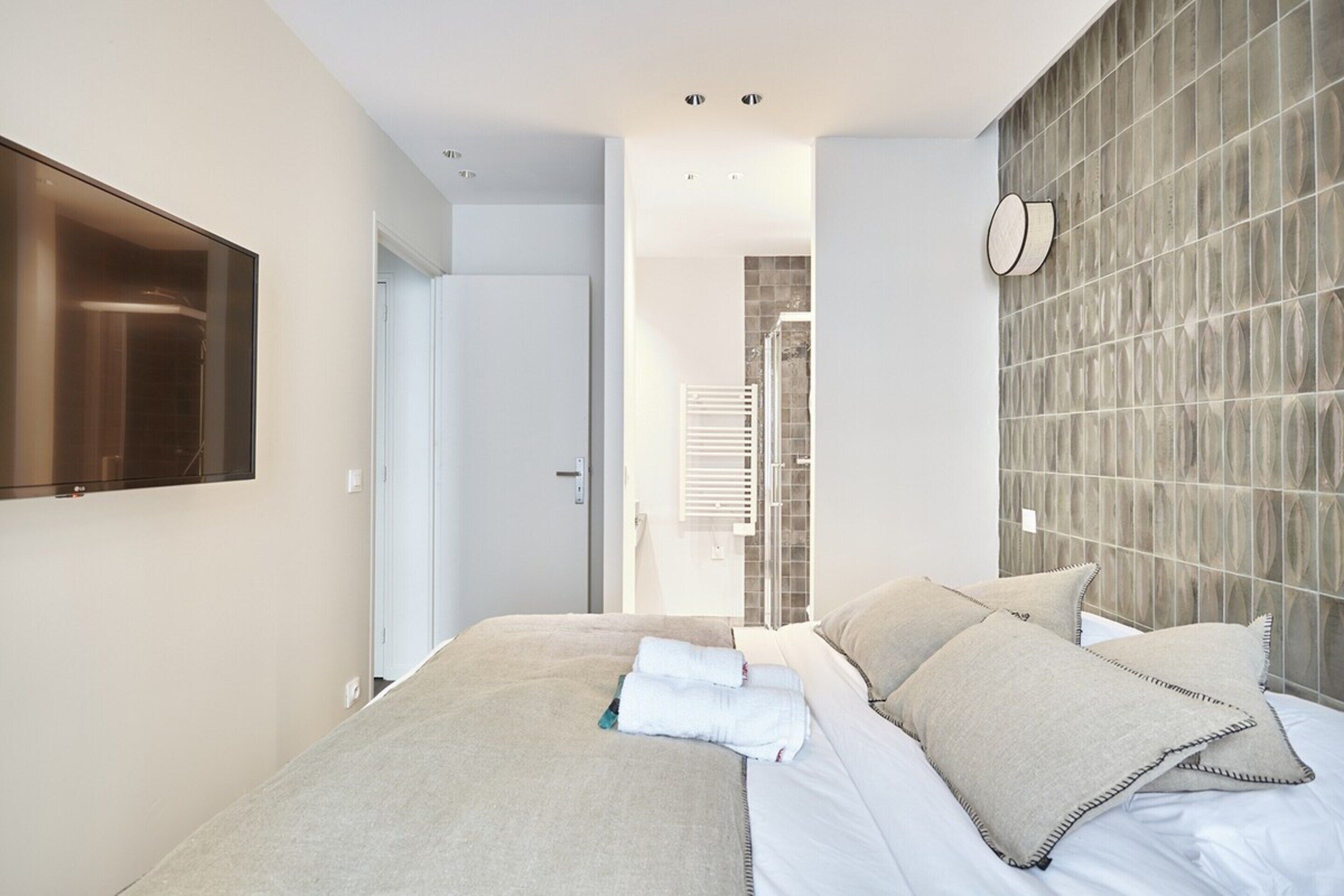 Laptop workspace, iron/ironing board, bed sheets