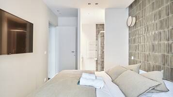 Laptop workspace, iron/ironing board, bed sheets