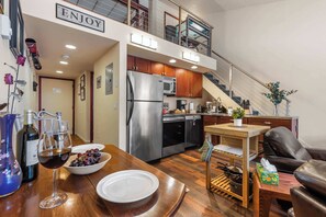 Enjoy casual dining in this kitchen with a central island, dining table, and modern appliances.