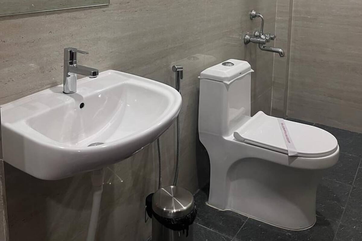 A modern bathroom with a sink, toilet, and shower.