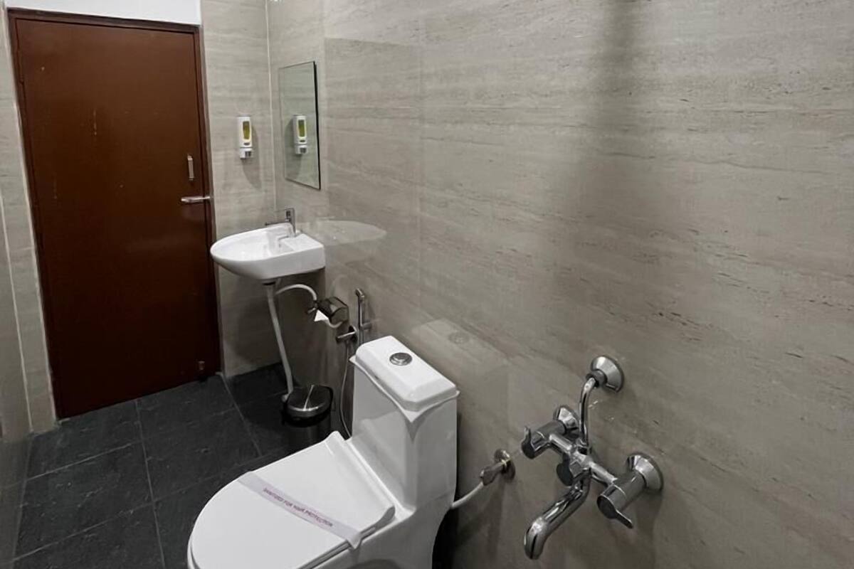 A modern bathroom with a toilet, sink, and shower.