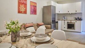 A modern kitchen with white cabinets and a built-in oven. - Apartment Paris Exposition Park Center (Paris)