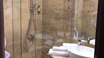 Bathtub, hair dryer, slippers, towels