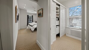 A bedroom with a bed, a closet, and a window with blinds. - This 2 bedroom 2 bathroom elegantly furnished home is ready for all your needs.  Featuring a primary bedroom suite, TV room, dining room, and additional sitting areas. (Chicago)