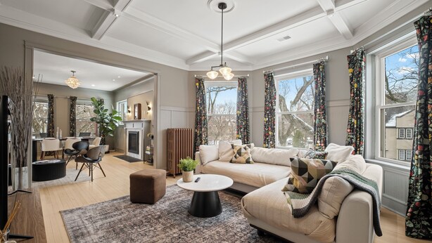 A spacious living room with a sofa, coffee table, and a fireplace. - This 2 bedroom 2 bathroom elegantly furnished home is ready for all your needs.  Featuring a primary bedroom suite, TV room, dining room, and additional sitting areas. (Chicago)