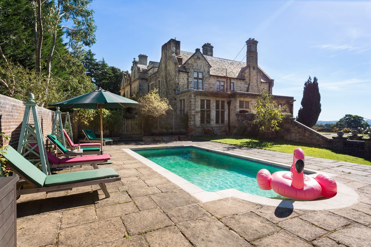 A swimming pool with lounge chairs and an inflatable flamingo float.