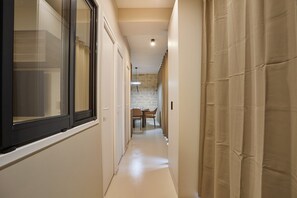 Stylish hallway leads to a dining area with a table and chairs.