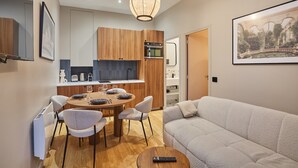Ein modernes Wohnzimmer mit einer Couch und einem Essbereich mit Tisch und Stühlen.