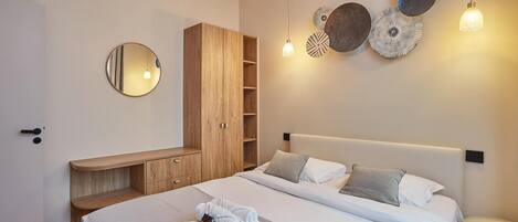 A modern bedroom with a bed, bedside tables, a wardrobe, and wall decorations.