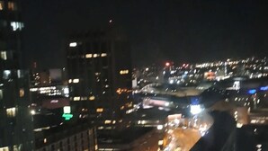 A nighttime cityscape with illuminated buildings and a busy street. - Luxury two bedroom skyline views apartment/Flat (Birmingham)