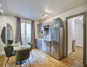 Enjoy meals in the kitchen with a dining area featuring a table and chairs.