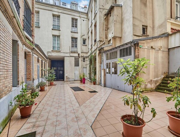 Stroll through this charming European-style alleyway, lined with potted plants and historic buildings.