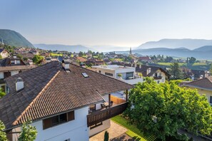A residential area with traditional architecture, including houses with sloped roofs and satellite dishes.