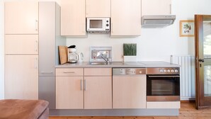 A compact kitchen with a microwave, coffee maker, sink, and oven. - 718B Apartment  Ansitz Wieshof (Caldaro sulla strada del vino)