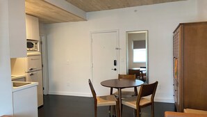 A compact living space with a kitchen, dining area, and a wooden cabinet.