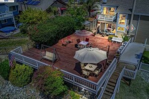 Outdoor dining - Waterfront modern home Sleeps 6 near Marina w/ Hot Tub, Large Deck, and EVCharge (Discovery Bay)