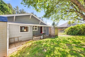 A single-story house with a covered porch, a small attached garage, and a well-maintained lawn. - Oceanside w/Views, Dog-Friendly, Gas Stove (Oceanside)
