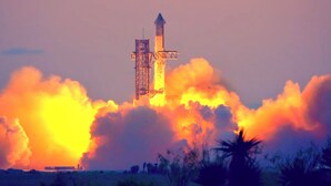 A rocket launch with a launch tower and smoke.