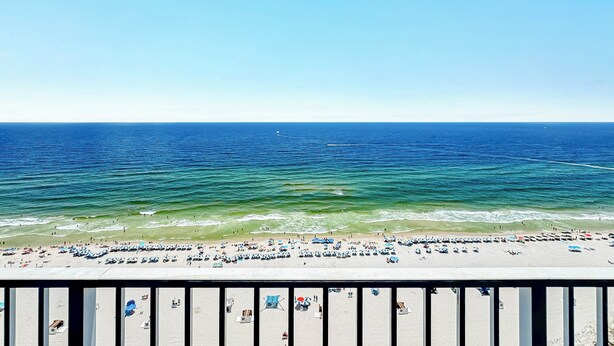 A beach with a clear view of the ocean and a sandy shore.
