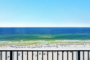 A beach with a clear view of the ocean and a sandy shore.