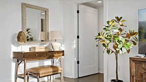 Work or unwind in a functional space with a desk, mirror, and plant.
