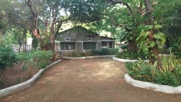 Surrounded by a beautifully maintained garden, this charming house offers a serene space with a front porch and a tranquil atmosphere.
