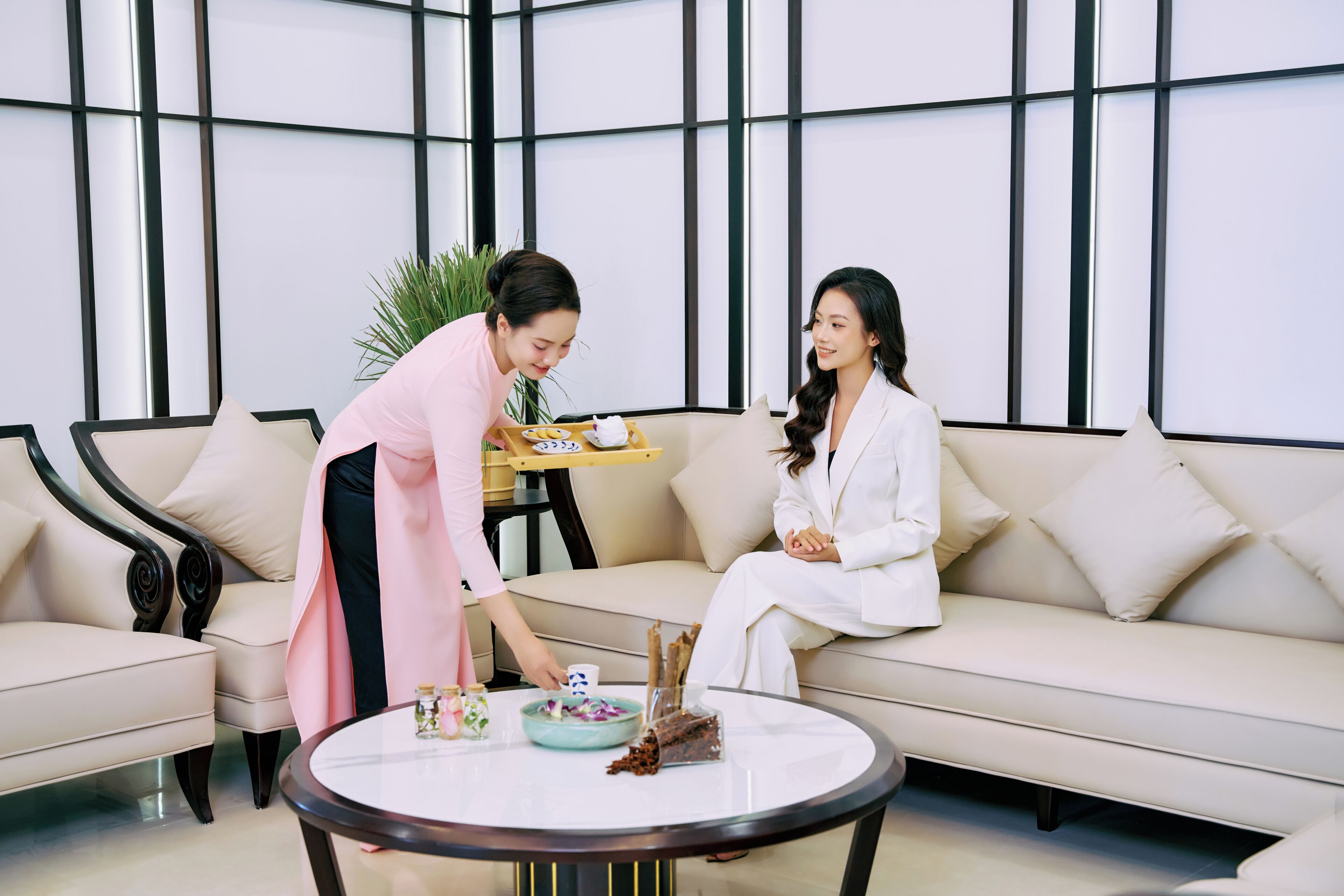 A modern interior with a sofa, a round table, and a tray with items.