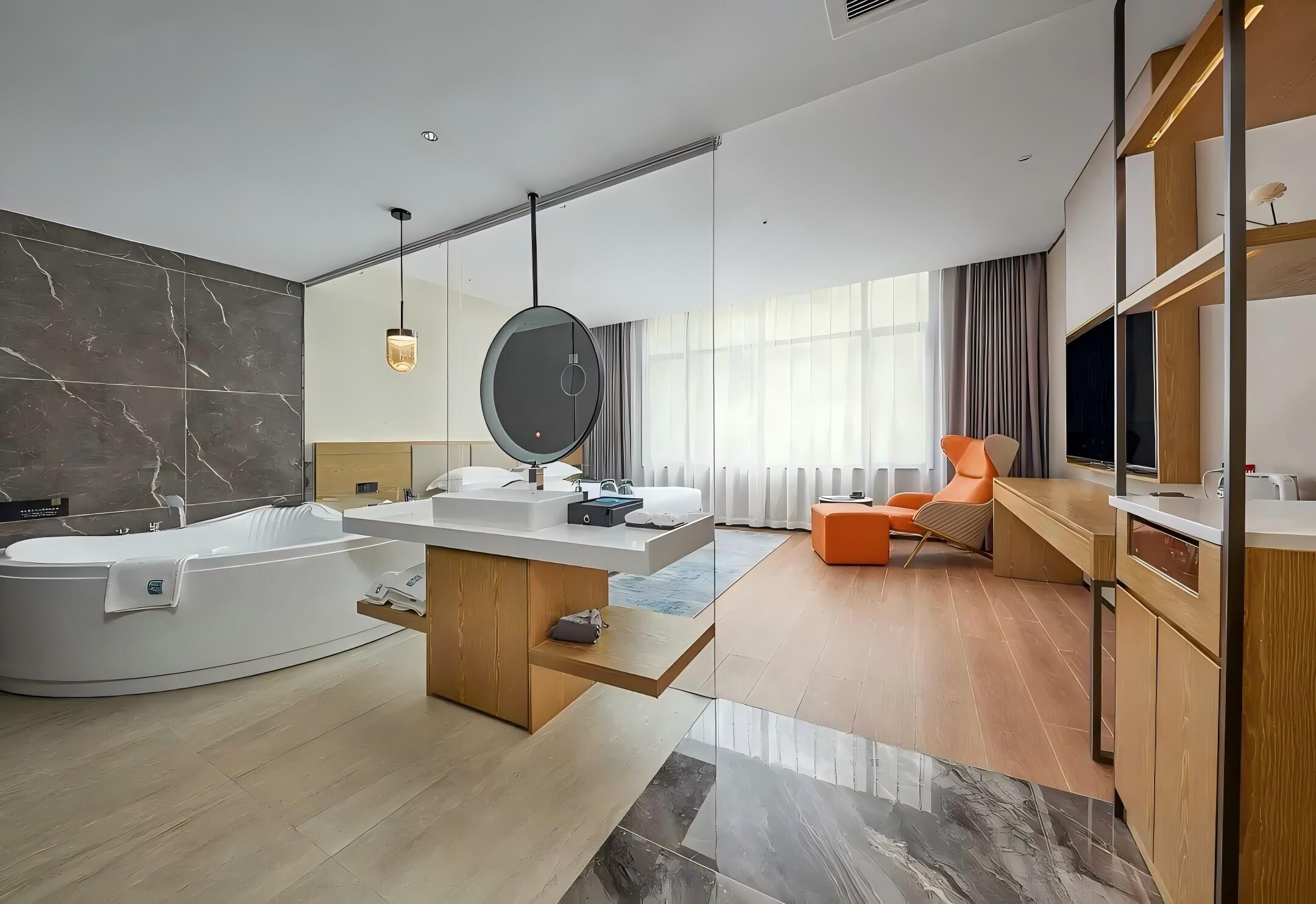 A modern bathroom with a freestanding bathtub, a vanity with a mirror, and a large window with curtains.