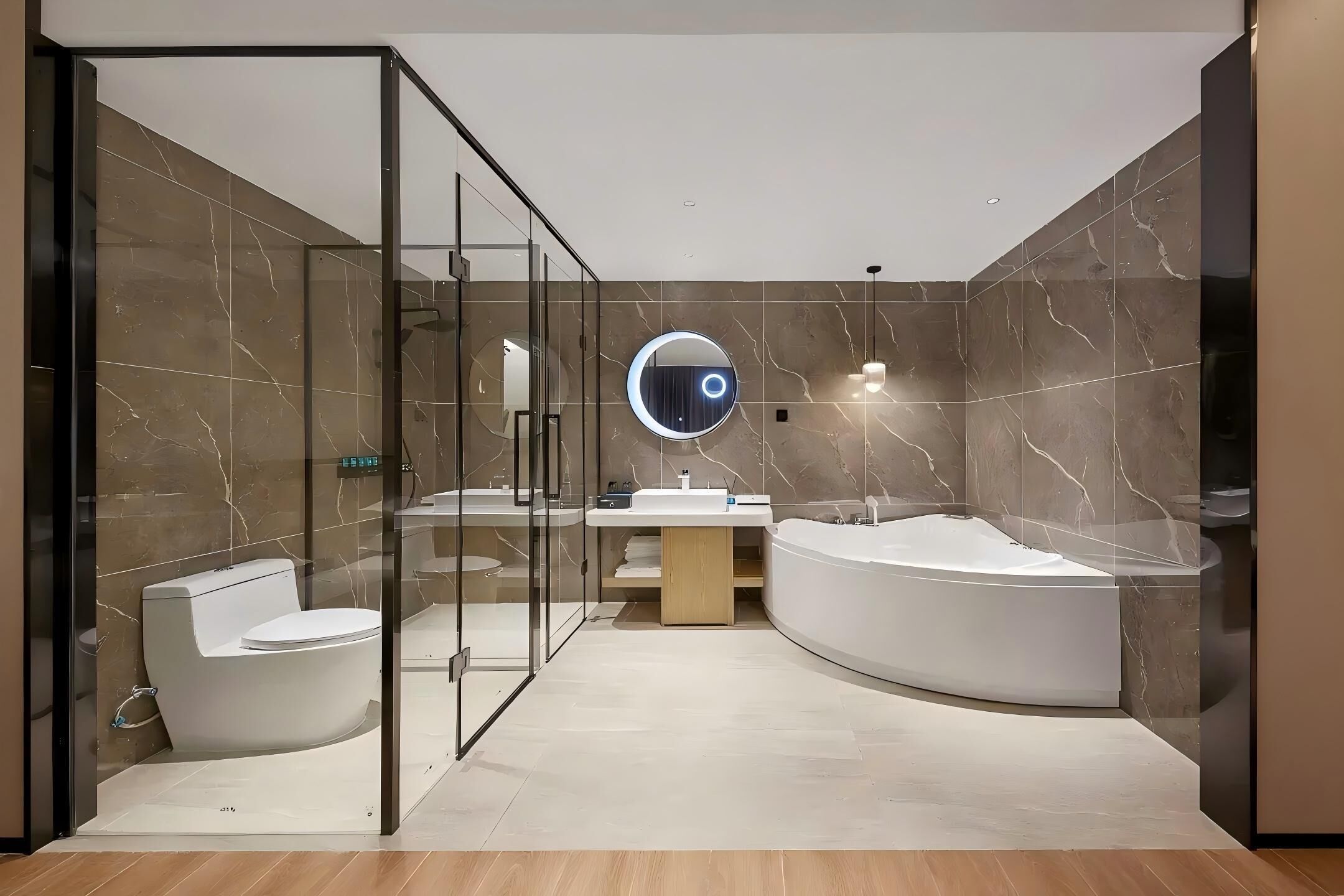 A modern bathroom with a glass-enclosed shower, a toilet, a sink, and a freestanding bathtub.
