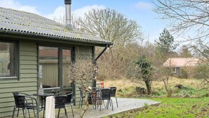A house with a deck, outdoor seating, and a chimney. - Lovely home in Samsø with WiFi (Samsø)