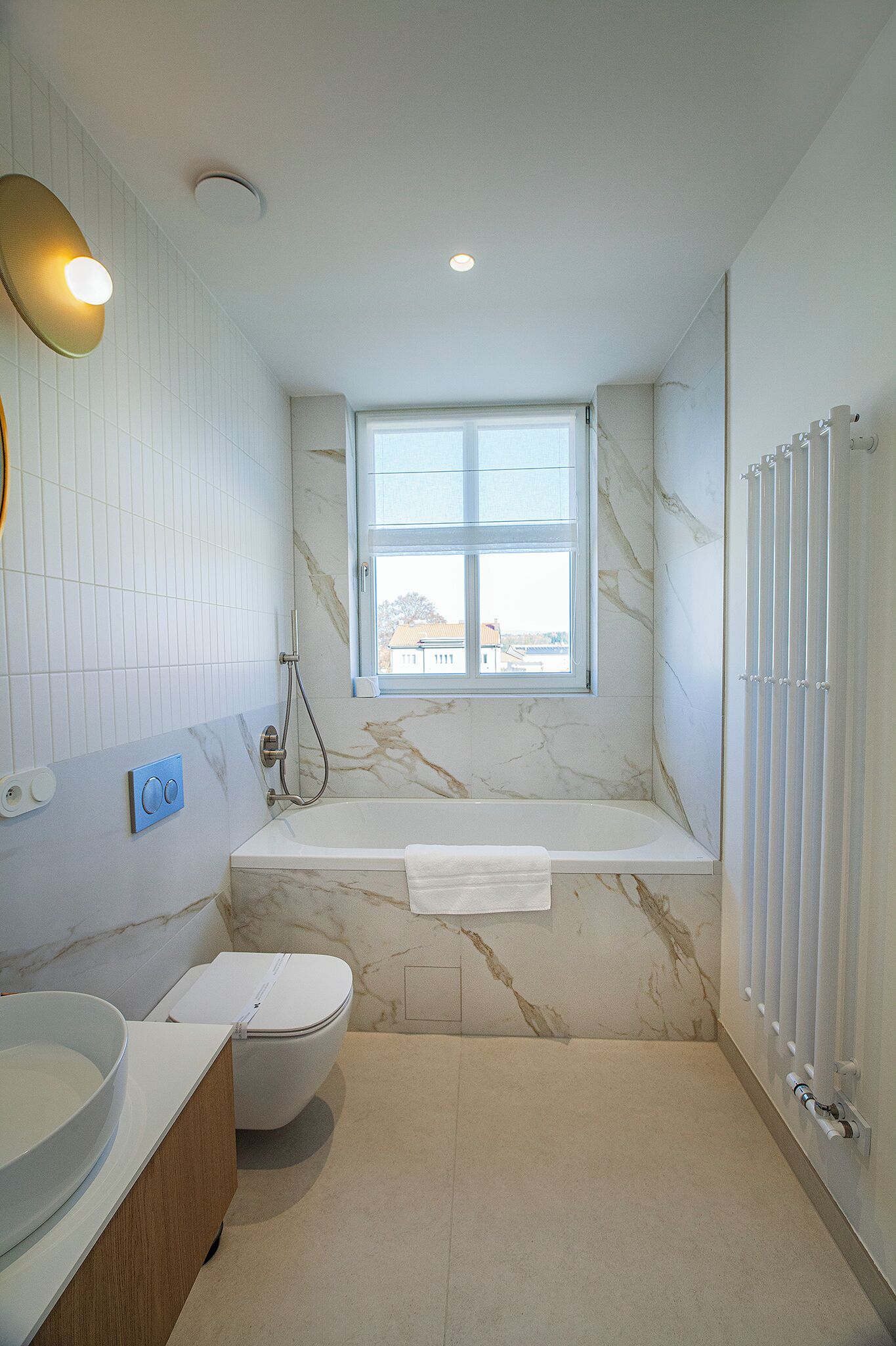 A modern bathroom with a bathtub, toilet, and sink.
