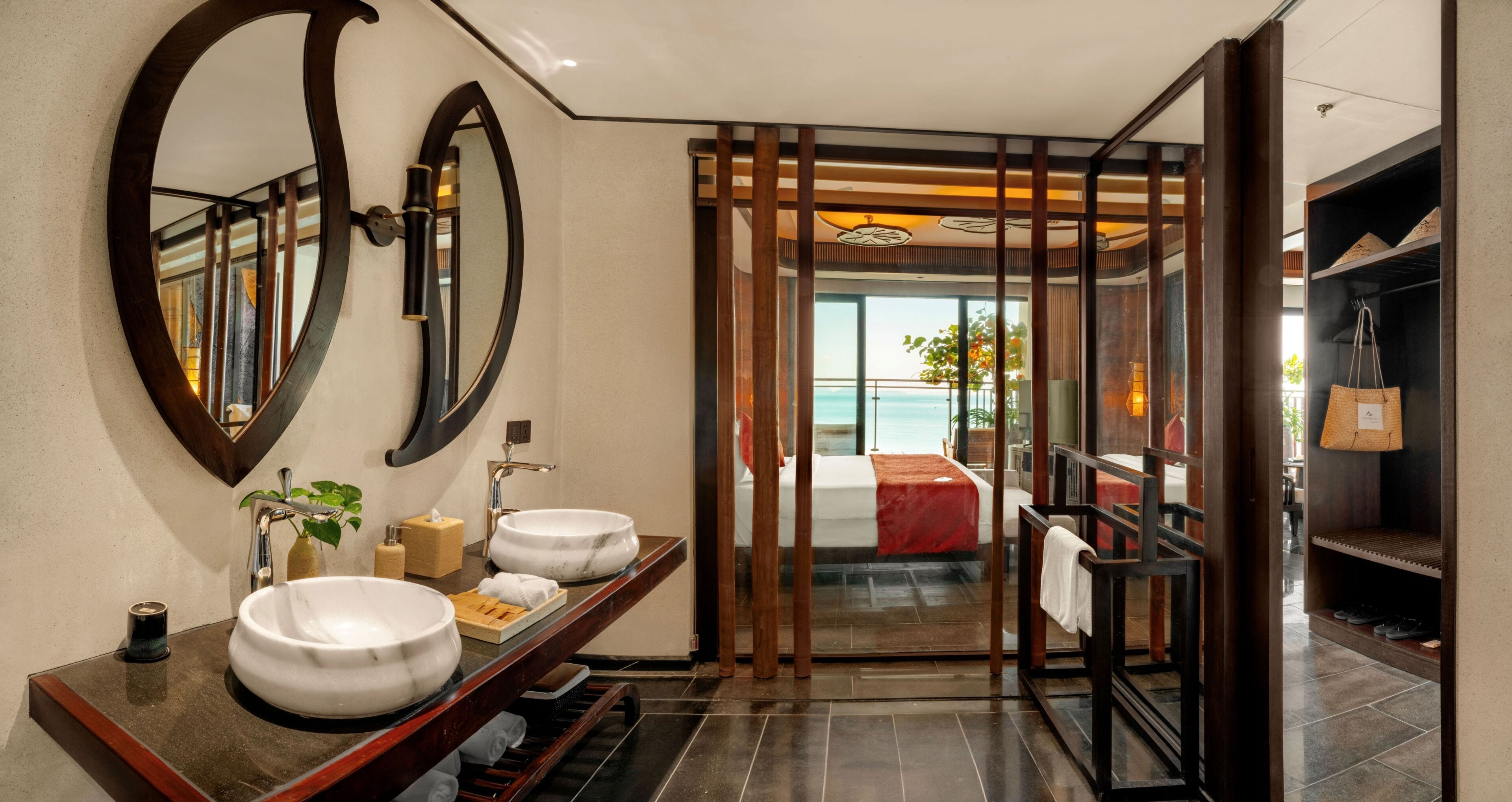 A bathroom with a large mirror, two sinks, a towel rack, and a view of a balcony with a pool.