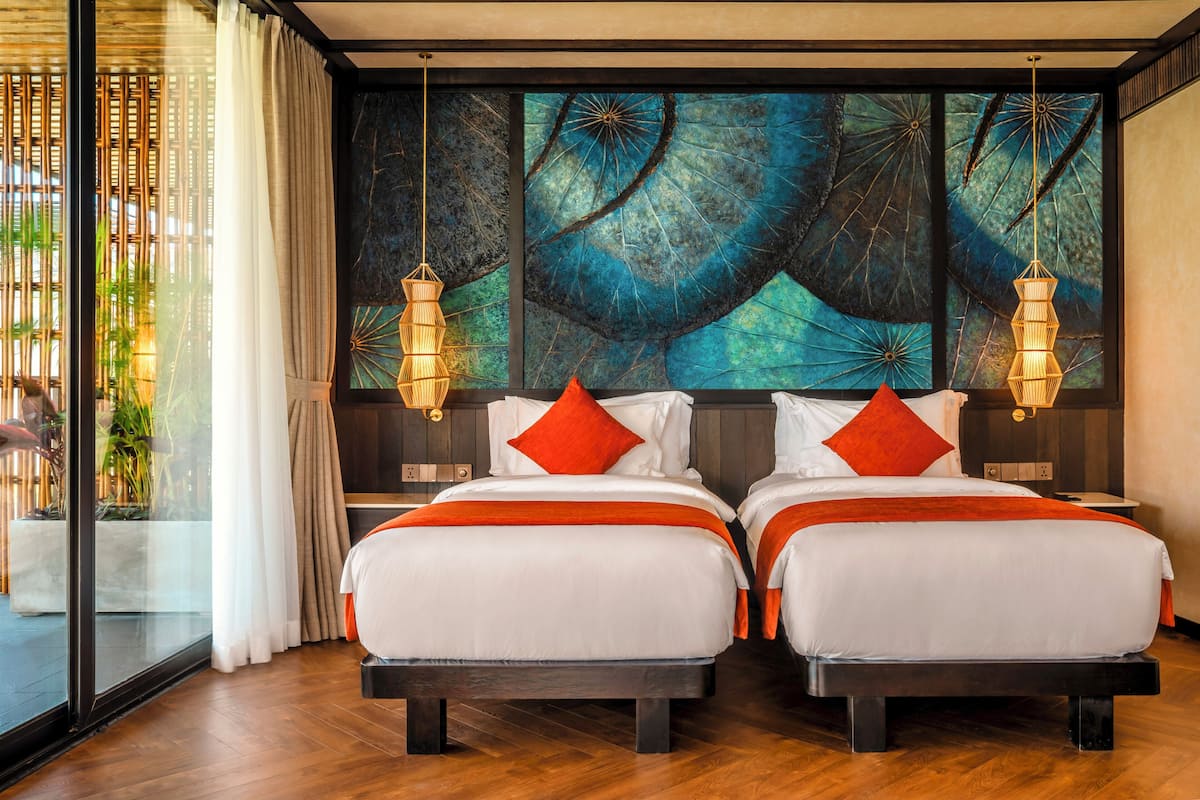 A double bed room with a large window, a wall mural, and two bedside lamps.