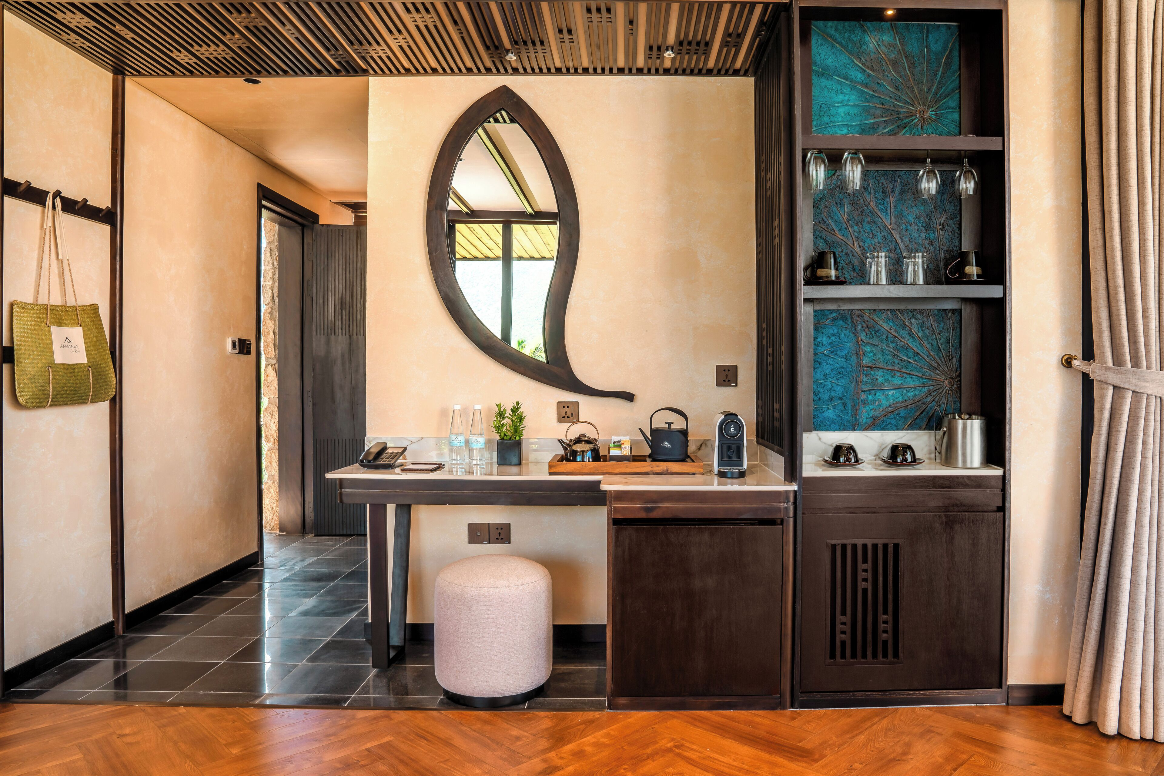 A modern kitchen with a large mirror, a wooden countertop, and a built-in stove.